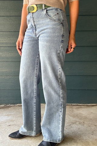 Women’s light wash high-rise jeans with a wide-leg fit, curved front pocket detail and full-length hem.