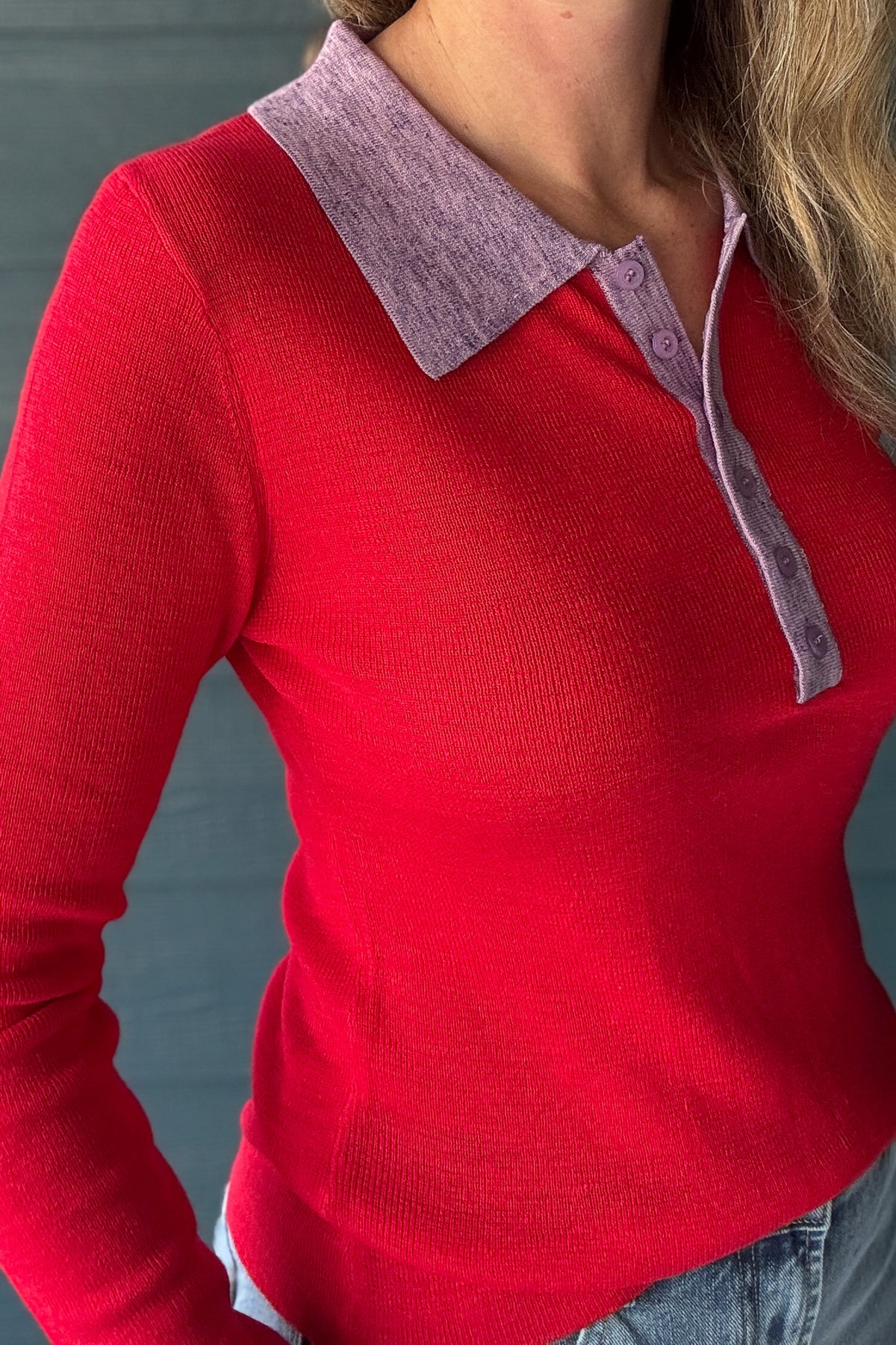 Women’s fitted red knit polo sweater with lavender contrast collar and long sleeves at Cotton & Cashmere women’s boutique in Blanco, Texas.