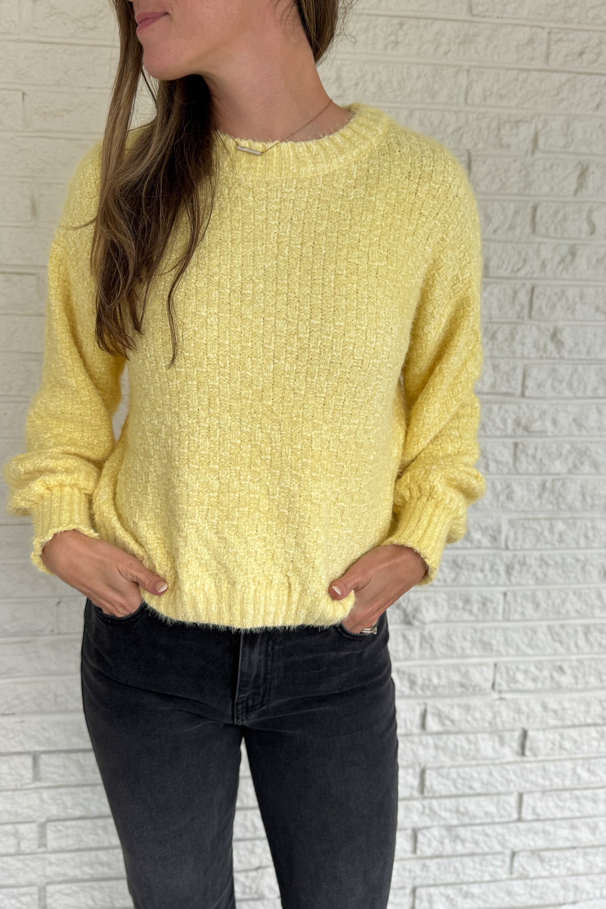 Soft, cheerful, and effortlessly cozy — this braided knit sweater adds a touch of sunshine to cool days. Its subtle checkered texture gives it dimension, while the classic crew neckline and ribbed edges keep it timeless. Easy to pair with denim or skirts for a bright, everyday look.