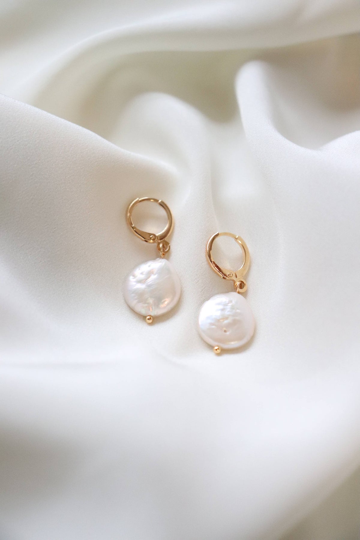 Our new Pearl Huggie Earrings have quickly become best sellers, they make great gifts and are so on trend. 18K gold plated hoop with natural pearl accent.