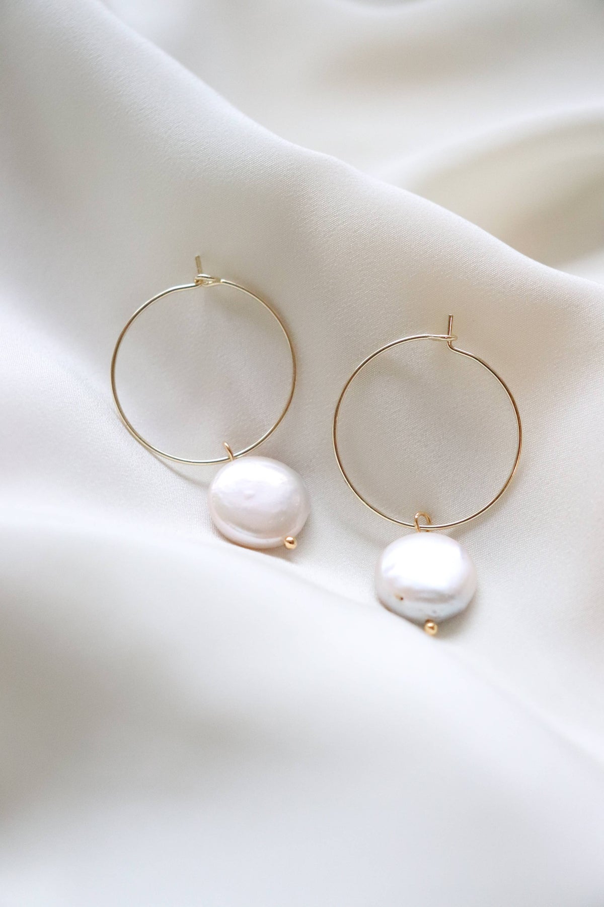 We are loving these pearl hoop earrings. 18K gold plated hoop with natural pearl accent.